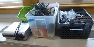 lot 219 image: Toshiba projector, totes of headphones, cassette player and tapes, bin of about 20 new ear buds