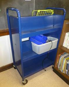 lot 220 image: Rolling double sided book shelf and contents