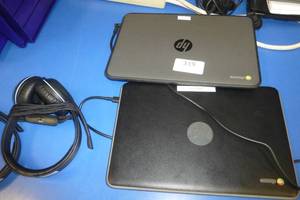 lot 319 image: TWO HP chromebooks in working condition and headphones