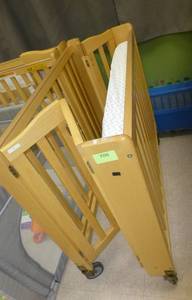 lot 708 image: Folding Baby Crib on wheels with plexiglass ends for easy monitoring