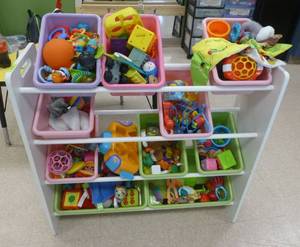 lot 723 image: Toy box shelf full of toys