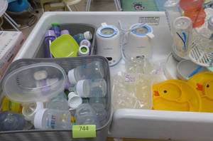 lot 744 image: All contents in the top of the baby changing station - bottles and bottle warmers