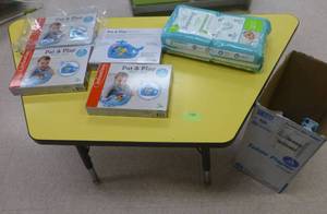 lot 748 image: Yellow kids table and 4 new water mats and diapers