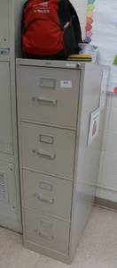 lot 922 image: File cabinet with contents including backpack on top