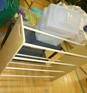 lot G94 image: Slanted bookshelf and black stand and 2 small clear totes