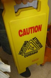 lot C60 image: 2 mop buckets and contents and slippery floor sign
