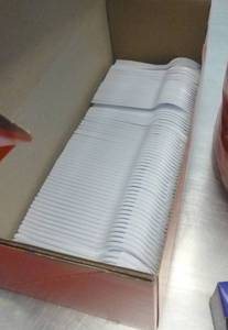 lot K7 image: Plastic utensils, reynolds wrap and large stack of 200 foam plates