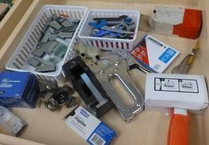 lot O21 image: Batteries, calculators, staplers, tape dispenser, temperature monitor, rubber bands, clipboards, pencils