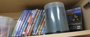 lot O50 image: DVDs and blank cds, Nikon Coolpix camera, computer cords, headsets, cd player, 2 external hard drives