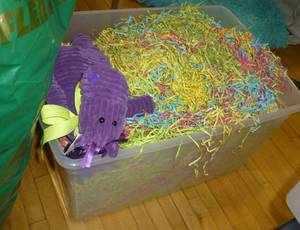 lot G93 image: Large garbage bag full of all new easter egg packs and easter grass