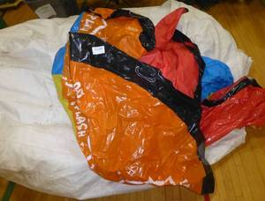 lot G124 image: Inflatable pool, and huge white bag, not sure what its for, but is full of shrink wrap