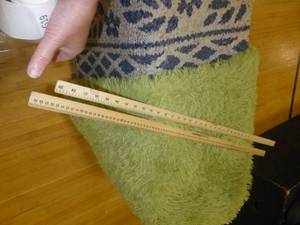 lot G18 image: Tote on wheels, rug, measuring sticks