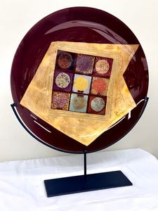 lot 12 image: Tony Evans Contemporary Red Art Glass Charger on Wrought Iron Stand