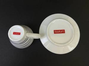 lot 137 image: Espresso Cups and Saucers by Bodum - Unique Black and White Designs