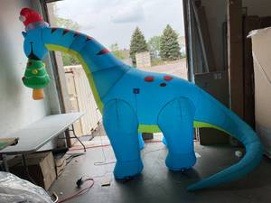 lot 304 image: COMIN 10ft Christmas Inflatable Dino Eating Christmas Tree