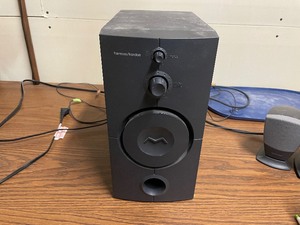 lot 235 image: Harmon Kardon Speaker System. Subwoofer And Two Stereo Speakers. Subwoofer Measuring 10 12 Inches Deep, 6 Inches Wide, 12 Inches Tall. Individual Speakers 3 14 Inches Wide, 5 Inches Tall.