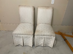 lot 238 image: A Pair Of Cloth Covered Dining Table Chairs, Off-White In Color. Each Chair Measuring 39 12 Inches Tall, 28 Inches Deep, 18 Inches Wide.
