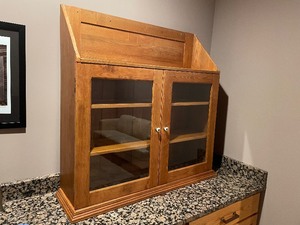 lot 204 image: Solid Wood Display Cabinet Measuring 44 Inches High By 42 Inches Wide By 12 Inches Deep. Glass Panel Doors With Two Shelves Inside.