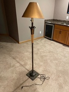 lot 211 image: Floor Lamp. Measuring 58 Inches Tall. Metal Base Measuring 9 x 9 Inches Square. Lampshade Measuring 13 Inches In Diameter By 9 Inches Tall. Minor Damage To Lampshade Where It Attaches To Frame.