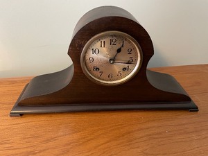 lot 213 image: Wooden Mantle Clock From New Haven Clock Company Model 50 A. Measuring 20 12 Inches Wide At The Base, 5 Inches Deep And 10 12 Inches Tall At The Tallest Point. Face Is 5 12 Inches In Diameter. Unknown Working Condition. Pendulum Is Detached Inside.