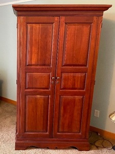lot 219 image: Hooker Furniture Cherry Entertainment Armoire. Measuring 76 12 Inches Tall By 44 12 Inches Wide At The Crown 23 12 Inches Deep. Two Large Doors. Shelves Power Strip Included. Additional Storage Inside With Four Drawers And Two Smaller Shelves.