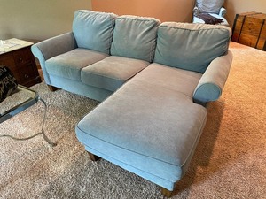 lot 229 image: Flexsteel Couch - Suede-Like Microfiber. Light Blue With Chaise On One End. Measures 84 Inches Wide By 39 Inches Deep. Chaise End Is 84 Inches Deep. Minor Stain Or Residue In A Couple Of Spots. Includes Two Throw Pillows.