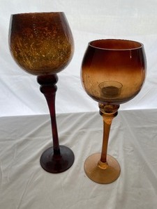 Two Decorative Tea Candle Holders. One Is 16 Inches Tall, the Other Is 14 Inches Tall.