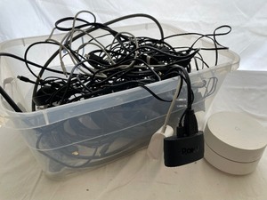 Bin of Miscellaneous Cables, Power Cords, a Roku and Google Home.