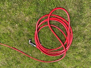 Red Heavy Duty Outdoor Hose and Husky Spray Nozzle.