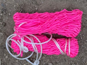 Two Bundles Of Mesh Fencing