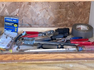 Shelf And Bucket Of A Variety Of Tools