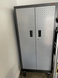 Gladiator Industrial Storage Cabinet. Has Heavy Duty Pivoting Casters. Includes Three Adjustable Shelves. Dimensions 65 12 Inches Tall by 30 Inches Wide by 18 Inches Deep.