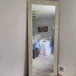 White wood carved trimmed mirror measuring 78 inches tall and 31 inches wide
