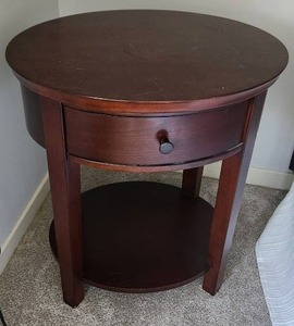 Pair of wood oval nightstands with drawer measuring 24 inches wide by 20 inches deep and 27 inches tall