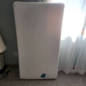 Crib mattress measuring 28 inches wide by 52 inches long