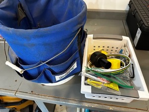 Shop bucket with electrical tools and household accessories