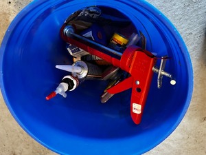 Bucket filled with caulking supplies