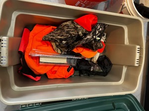 Bin of hunting supplies and dog hunting vests