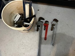Bucket of large wrenches and miscellaneous tools