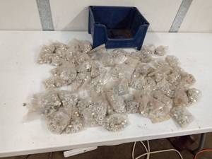 lot 49 image: Bin of new nuts in packages