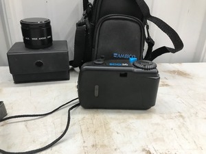 lot 516 image: Canon T70, Vivitar ECO35 in case, Revere S1 Super 8 movie camera with manual and case, and MADO aux wide angle lens
