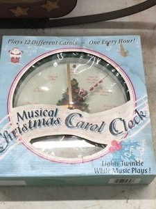 lot 521 image: Reel of Christmas lights, Musical Christmas carol clock, dog in sled