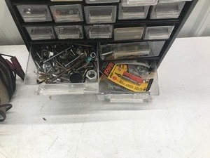 lot 617 image: 3 hardware storage organizers with hardware, triangle sign for tractor, Schauer motorcycleautomotive battery charger