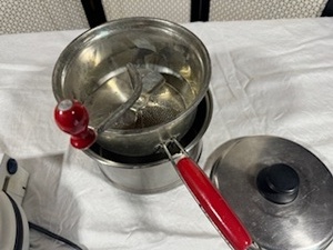 lot 75 image: Heavy Duty Pot and Lid with Vintage Applesaucer Maker and Oster Designer Waffle Maker