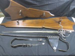 lot 2 image: (RM2) Musketeer Rapier Sword  Main Gauche - Maker Arms & Armor, Mpls. MN - Includes Scabbard, Belt and 2 Wood Wall Plaques - Valued At $2,500 to $3,500 - Sword 42 12 Overall Length
