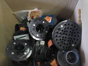 box of new plastic floor drains...