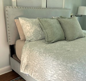 lot 33 image: Plush Upholstered King Bed Frame with Nicole Miller Bedding