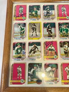 lot 10 image: Large Framed 28 Card Minnesota North Stars Hockey Cards with 10 Signed -  Lou Nanne, J.P. Parise, Jim Drouin, Bobby Smith, Bill Goldsworthy, Dennis Hextall, Barry Gibbs, Tim Young, Cesare Maniago, Henry Boucha