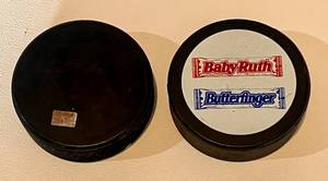 lot 62B image: Two Minnesota North Stars Vintage Hockey Pucks