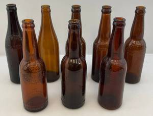 lot 133 image: Misc. Antique Embossed Amber Glass Beer Bottles